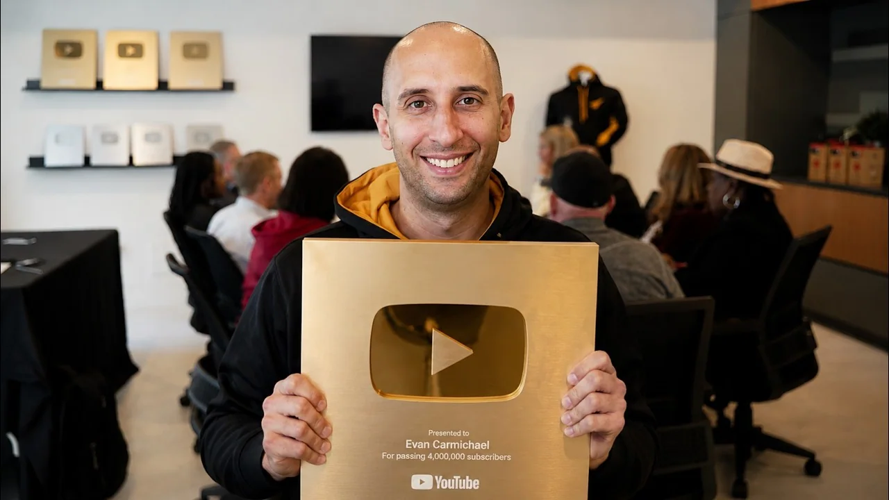 Evan Carmichael holding a YouTube award at the MasterMind event, with attendees behind him